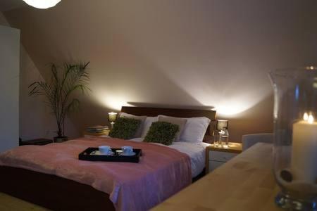 a bedroom with a bed with a tray on it at Cherry Tree Guest House in Gdańsk