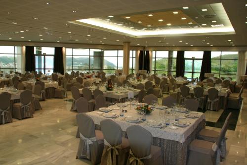 a banquet hall with tables and chairs in a building at Hotel Palacio de la Magdalena in Soto del Barco