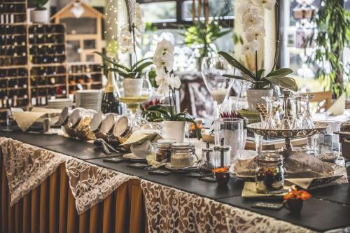 a table with plates of food on top of it at Altstadt Pension Orchidee in Wernigerode