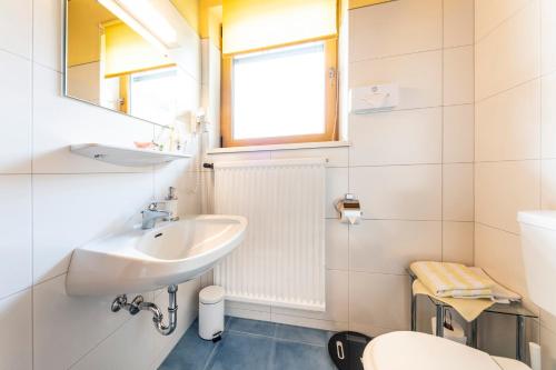 a small bathroom with a sink and a toilet at Pension Südhang in Bad Kleinkirchheim