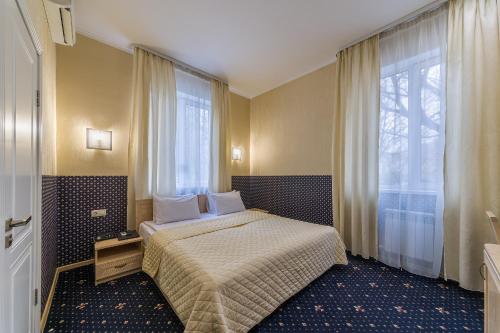 a hotel room with a bed and a window at Mira Hotel in Moscow