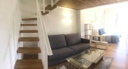 a living room with a couch and a staircase at Hotel Leonor de Aquitania in Cuenca
