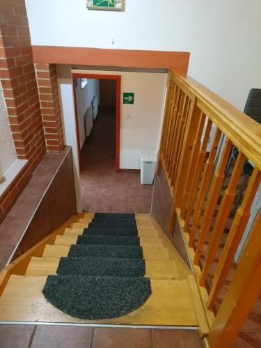 a stairway leading to a hallway with a stair case at Penzion Forest in Rozvadov