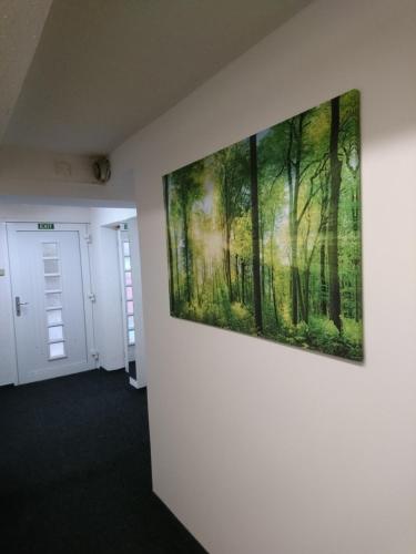 a painting of a forest on a wall at Penzion Forest in Rozvadov