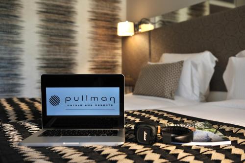 a laptop computer sitting on a table in a hotel room at Pullman Dakar Teranga in Dakar