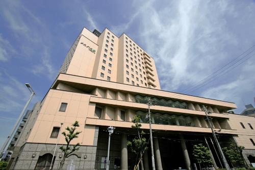 a large tan building with a sky in the background at Hotel Mielparque Nagoya in Nagoya