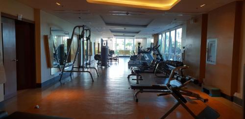 a gym with rows of treadmills and exercise bikes at Mactan Newtown Ocean View 360 Degree in Mactan