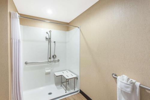 a bathroom with a shower and a sink at Wyndham Anaheim in Anaheim