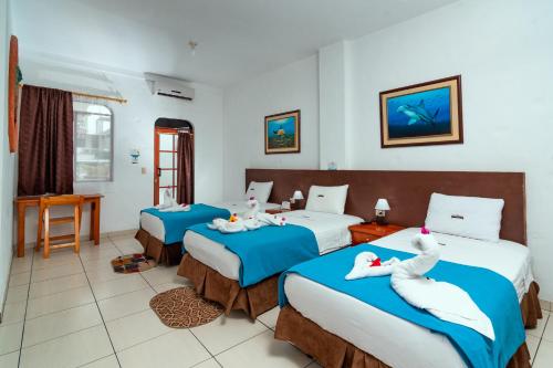Postel nebo postele na pokoji v ubytování Hotel Coloma Galapagos