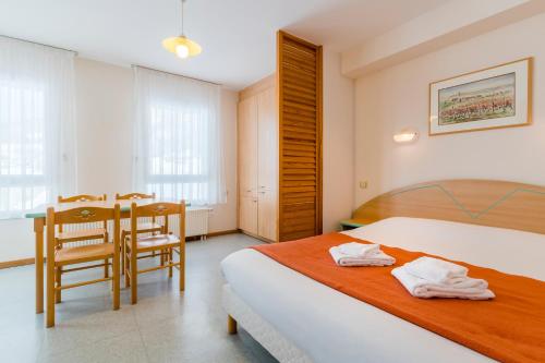 a bedroom with a bed and a table and chairs at Azureva Bussang in Bussang
