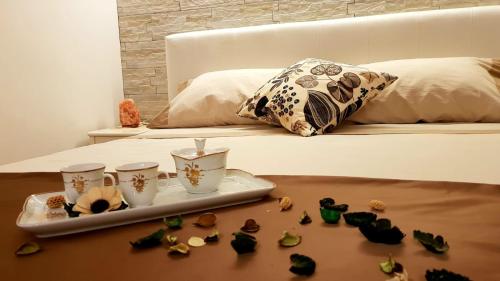 un letto con vassoio e alcune conchiglie su un tavolo di CentroCittà Suite a Catania