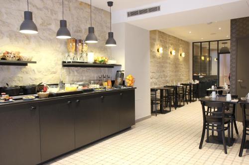 فندق بيست ويسترن أوبرا دروو في باريس: مطعم مع كونتر وطاولات وكراسي