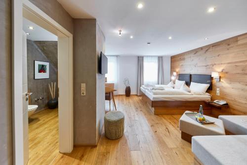 a large living room with a bed and a couch at Die Reichsstadt - Hotel Spa und Restaurant in Gengenbach