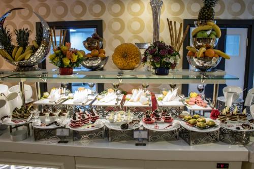 a buffet with many different types of food on display at King Sky Tower Hotel in Batumi