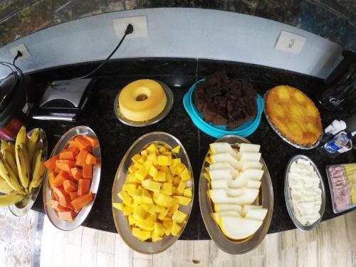 a bunch of different types of food on a table at Pousada Guapuruvu in Abraão