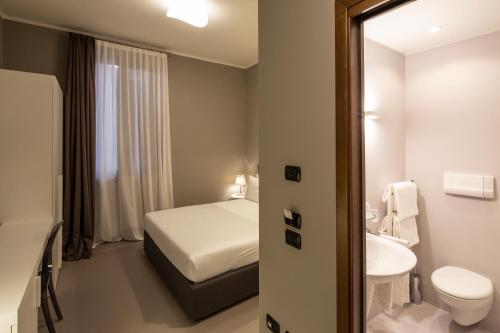 a small bathroom with a bed and a sink at Isola di San Servolo - Centro Soggiorno in Venice