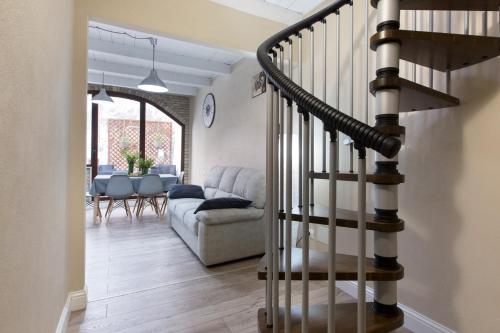 a living room with a staircase and a couch at White House in Cagliari