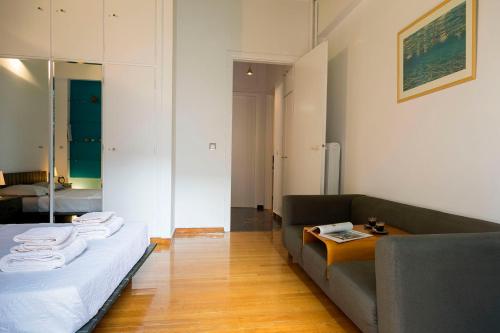 a living room with a couch and a table at Your home @Acropolis Museum in Athens