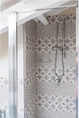 a shower in a bathroom with a shower curtain at White House in Cagliari