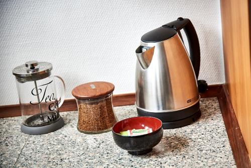 a tea kettle and other kitchen items on a counter at Fredericia Apartment II in Fredericia