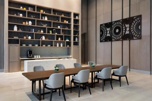 a dining room with a wooden table and chairs at Clark Marriott Hotel in Clark