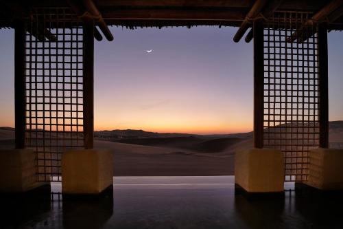 a view of the desert from a room with a window at Anantara Qasr al Sarab Desert Resort in Jurayrah