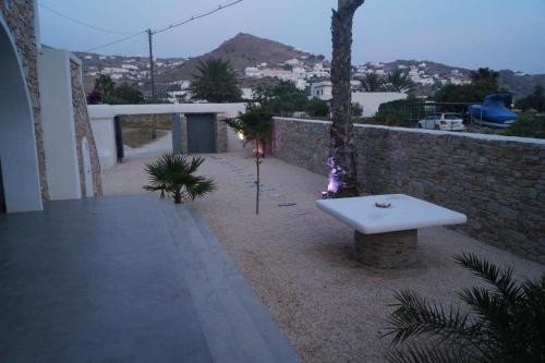 a white bench sitting on the side of a building at STUDIOSWORX Apartments in Ios Chora