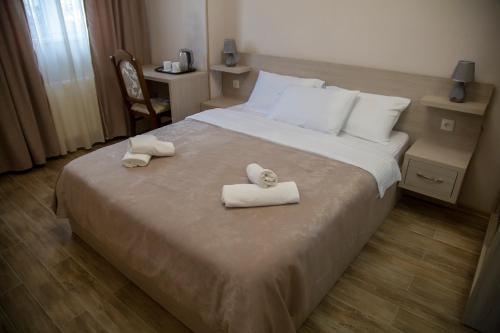 a hotel room with a bed with towels on it at Family Hotel Triston in Tbilisi City
