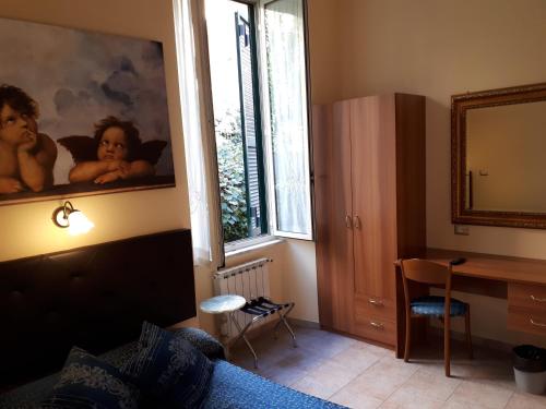 a room with a bed and a desk and a mirror at Hotel Major Aventinus in Rome
