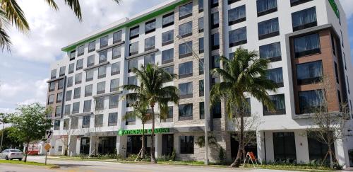 an office building with palm trees in front of it at Wyndham Garden Ft Lauderdale Airport & Cruise Port in Dania Beach