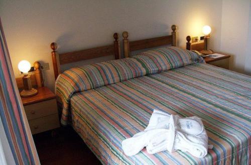 a bedroom with a bed with towels on it at Il Fraitevino hotel bed & breakfast in Sestriere