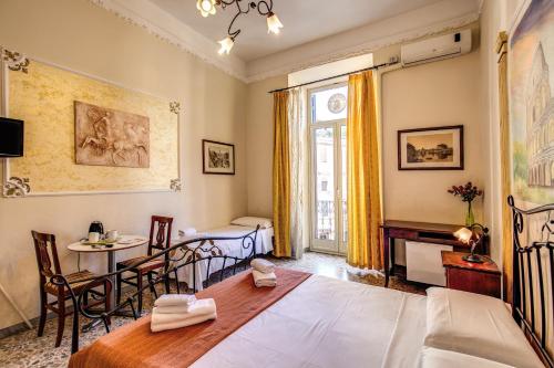 Pokój z łóżkiem, stołem i krzesłami w obiekcie Magenta Collection Manara 4 w Rzymie