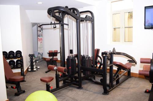 a gym with several tread machines in a room at Monty Suites & Golf in Uyo