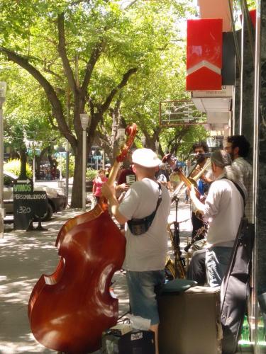 a group of people playing instruments on the street at Plaza Independencia in Mendoza