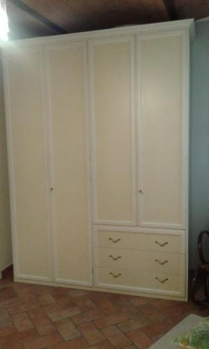 a large closet with white cabinets in a room at Da Giovanni e Marcella in Certaldo