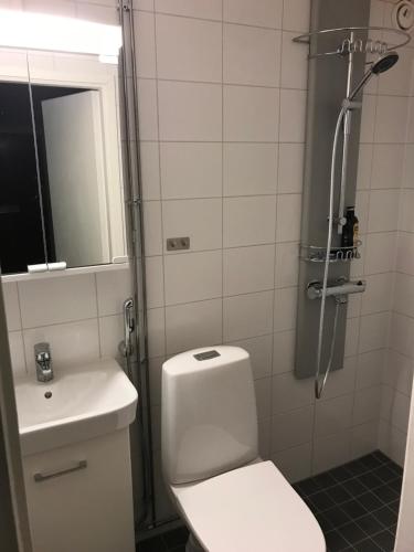 a bathroom with a shower and a toilet and a sink at M Apartments Tuularinkatu in Tampere