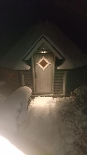 a front door of a house covered in snow at Villa Loch Nr.5 in Litschau