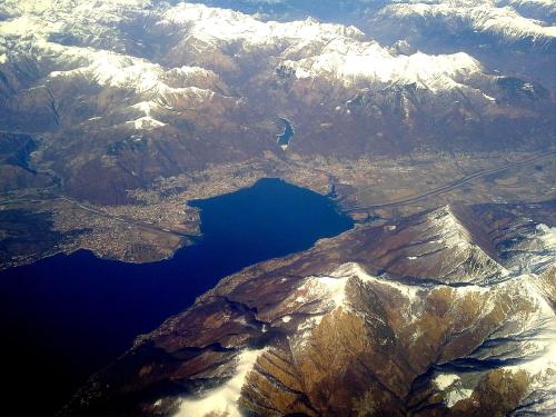 an aerial view of a lake in front of mountains at Verzaschina in Gordola