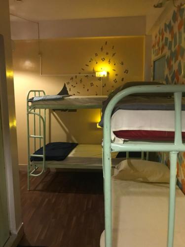 a dorm room with two bunk beds in it at The Little Blue Window Hostel in Bengaluru