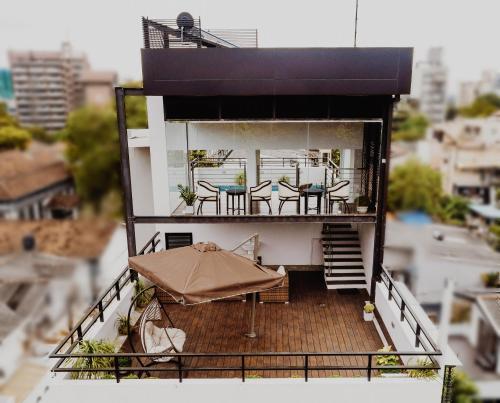 a balcony with tables and chairs and an umbrella at Lavonca Boutique Hotel in Colombo