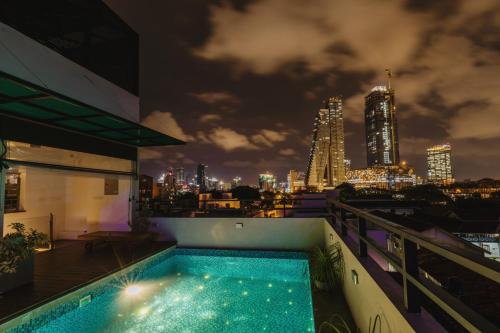 a swimming pool on top of a building with a city skyline at Lavonca Boutique Hotel in Colombo