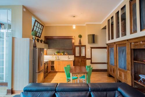 a living room with a couch and a kitchen at School 31 Lofts in Rochester