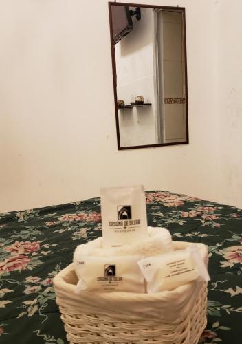 a basket of towels on a table with a mirror at Casona de Sillar in Arequipa