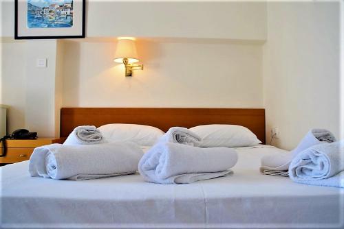 a bedroom with two beds with white towels on them at Attica Hotel Ephie in Souvala