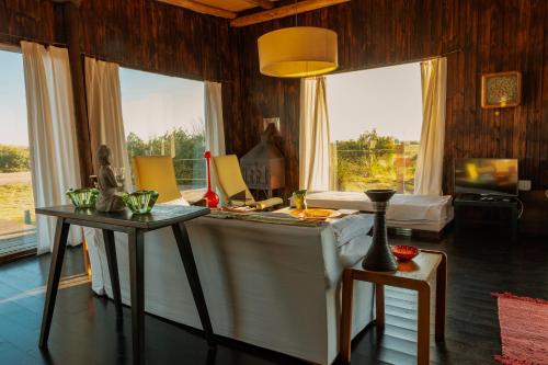 a living room with a couch and a table and windows at BDL Beach Design Loft One in José Ignacio