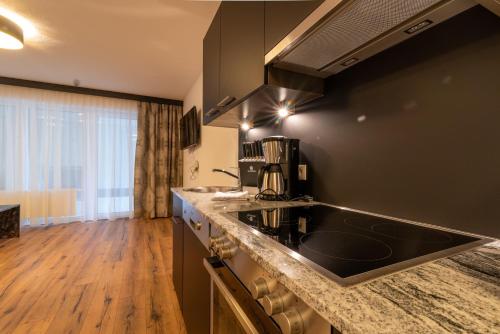 a kitchen with a sink and a counter top at A CASA Rubin Chalet & Studio Resort in Sölden