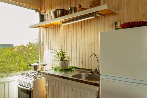 a small kitchen with a sink and a refrigerator at BDL Beach Design loft Two in José Ignacio
