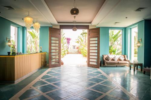 a lobby with a door and a couch in a room at ROBINSON AGADIR - All Inclusive in Agadir