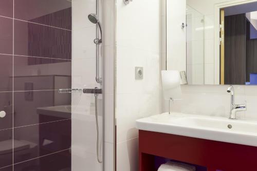 a bathroom with a sink and a shower at Mercure Toulouse Sud in Toulouse