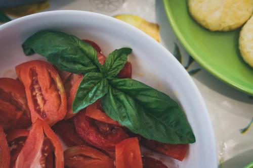 a bowl of vegetables with a basil leaf on top at Oleum in Massa Lubrense
